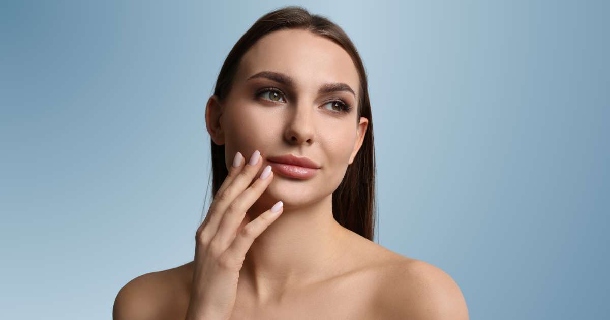 A beautiful woman touching her lip area.