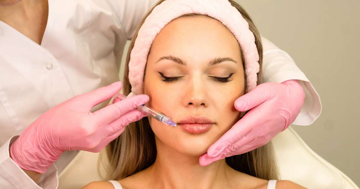 A woman receiving a lip filler injection.