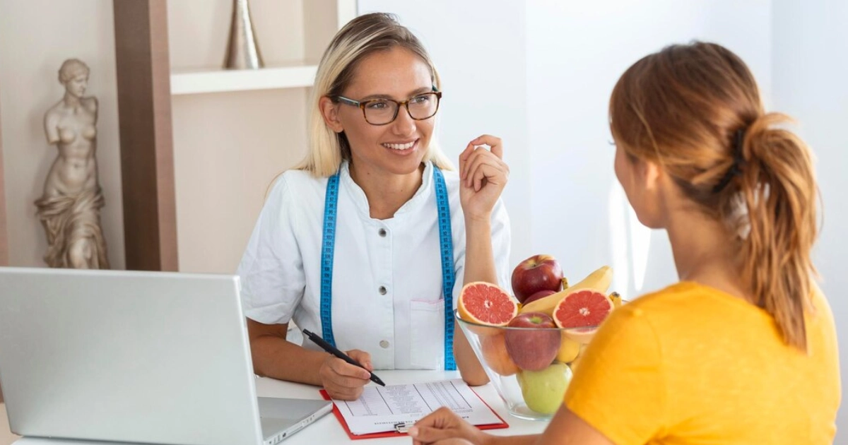 A medical provider talking to a woman patient.
