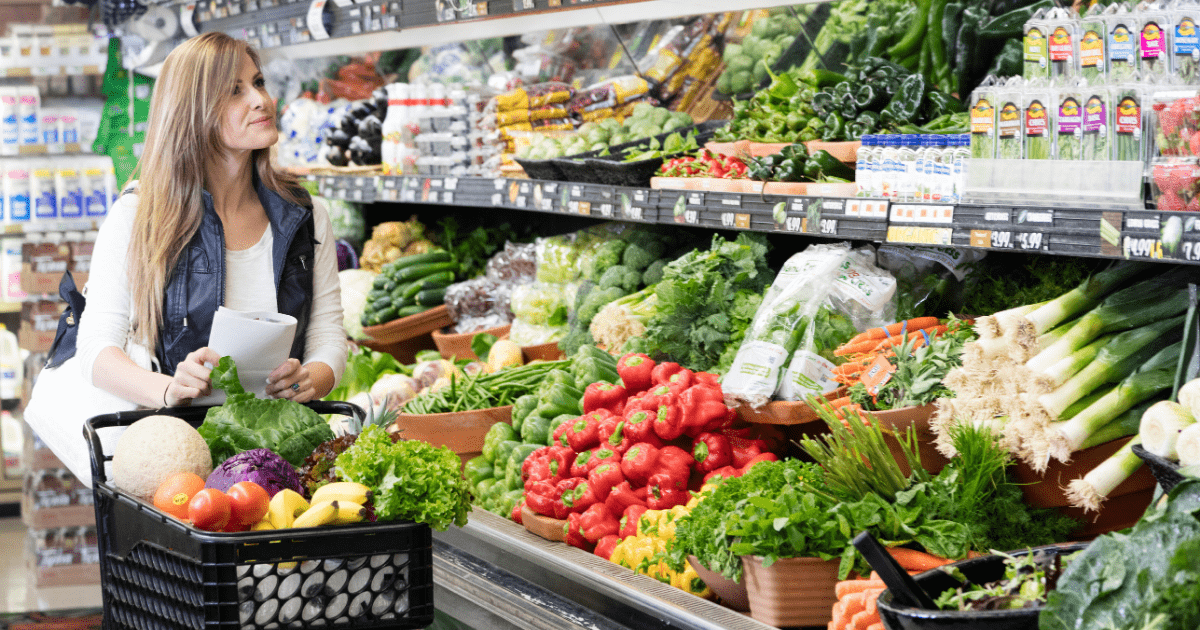 a woman on a grocery shopping around fruits and vegetables