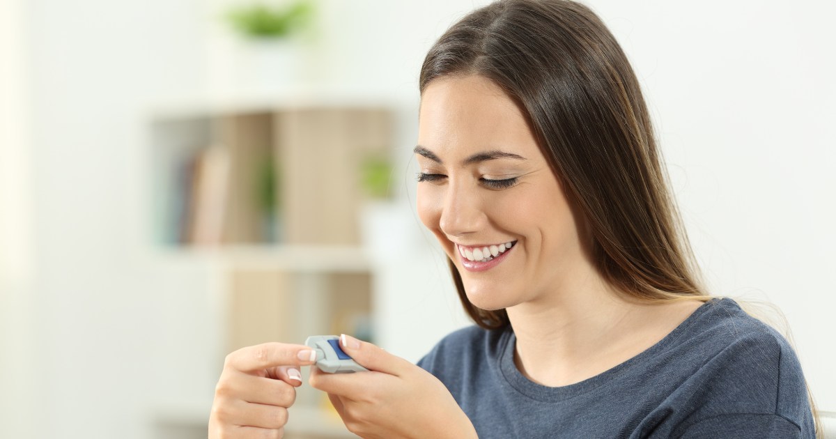 image of a woman checking her blood sugar